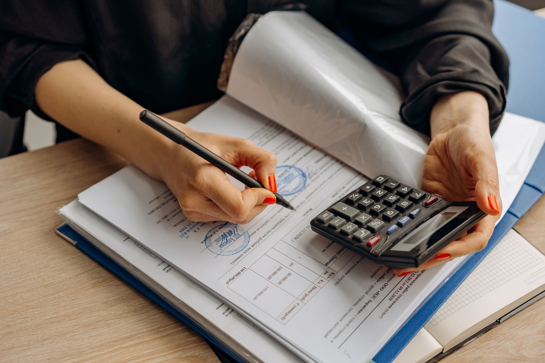 Accountant reviewing paperwork with a calculator